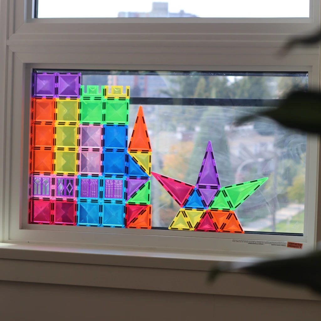 Colorful Tessella Spark Set – 50 Piece Magnetic Tiles arranged on a window, showing light refraction and creative STEM play for kids ages 3+